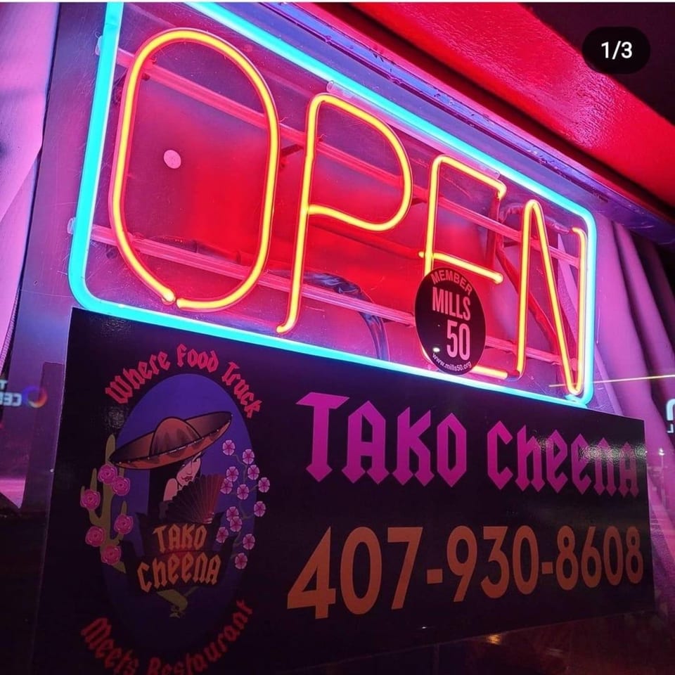 Tako Cheena's neon "OPEN" sign in red and yellow, with the restaurant's logo and phone number below.